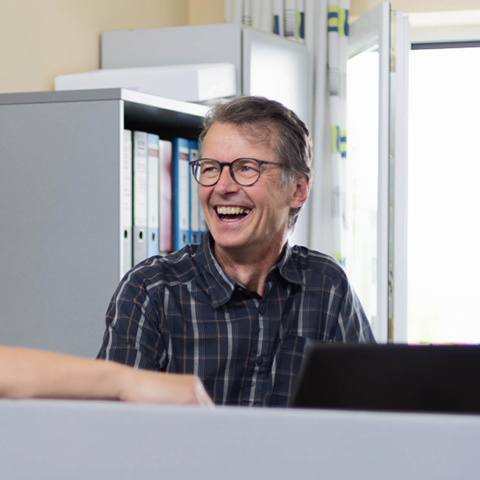 Gruppe von Fachleuten bei einer Jobmesse, die über künftige Chancen diskutieren.