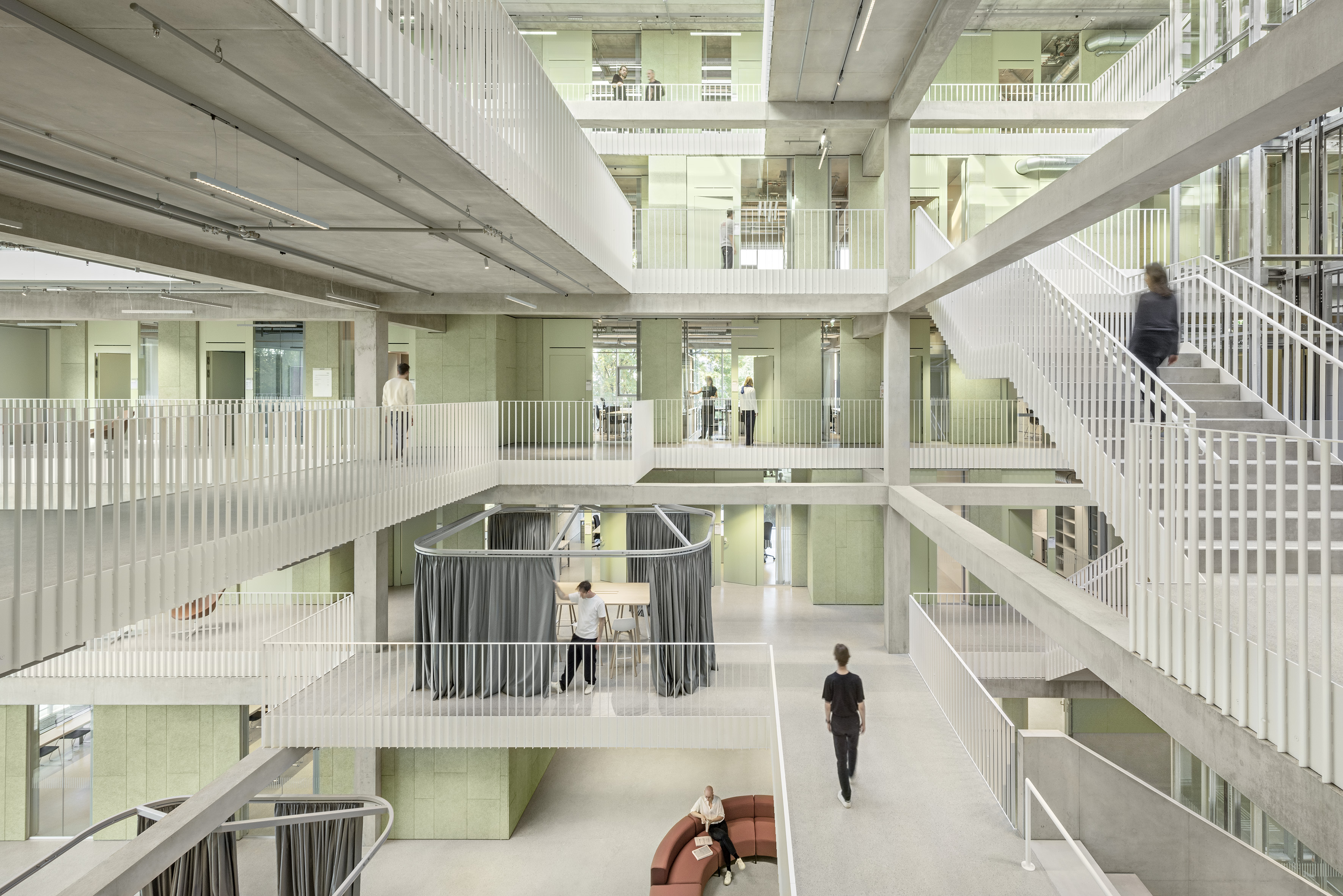 The interior view of the atrium in the House of Schools shows flexible spaces made of reinforced concrete and steel.