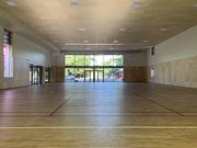 Interior view of a modern multi-purpose hall, with timber features and abundant natural lighting