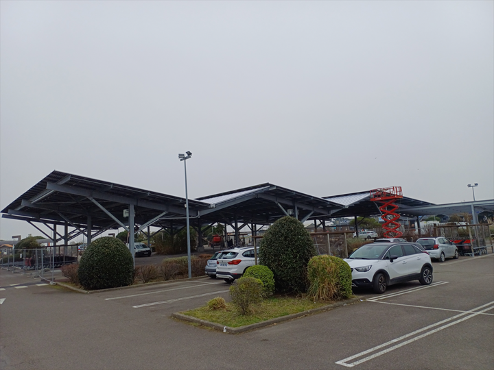 Photovoltaic roofing structures protecting vehicles and motorists while producing clean energy in the Vendée.
