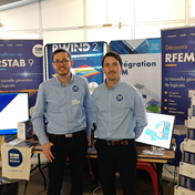 Colleagues meeting to share knowledge and exchange information at a conference on metal structures.