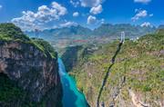 Drone view of the impressive Beipanjiang Bridge in China. The bridge spans a deep canyon and shows engineering skills in a breathtaking setting.