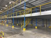 Two-Tier Steel Mezzanine in Warehouse by ALMACON Storage Systems BV.