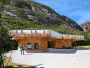 Exterior view of a modern service building in front of a scenic landscape at Torghatten.
