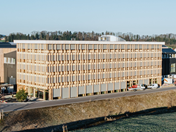 Modern office architecture in timber structure with large window front, designed by Blumer Lehmann.