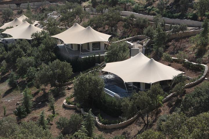 Steel membrane roof structures in a picturesque mountain landscape.