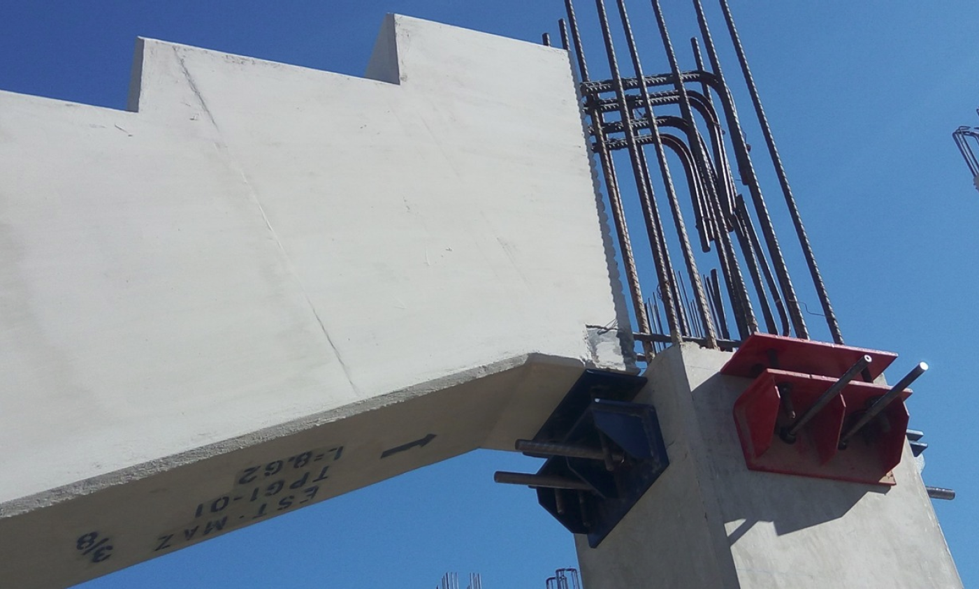 Detail of the structural connection of a grandstand with steel and reinforced concrete elements.