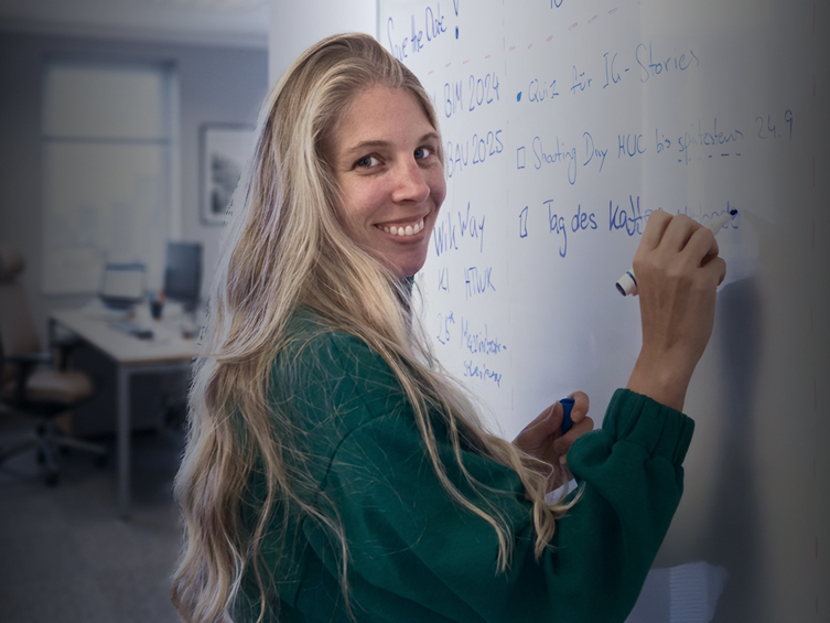 Nicole Schrameier poses in an office setting, highlighting professional attire and demeanor.