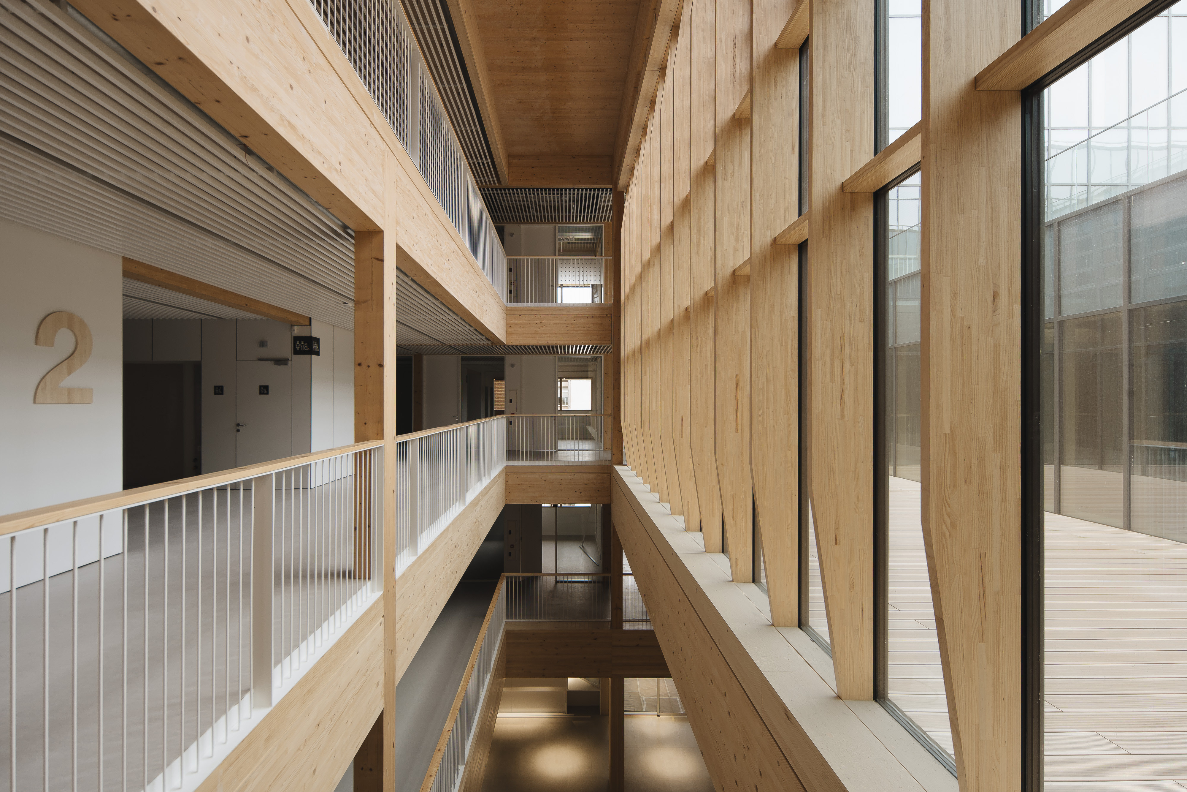 Interior of the UPNA with contemporary design, atrium-style space, levels with corridors and large windows.