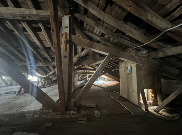 Dismantling of a timber truss in the roof structure.