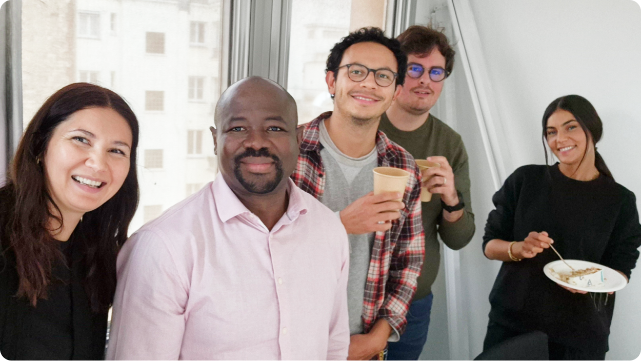 A group of colleagues collaborating in a modern office space, reflecting a positive work environment.