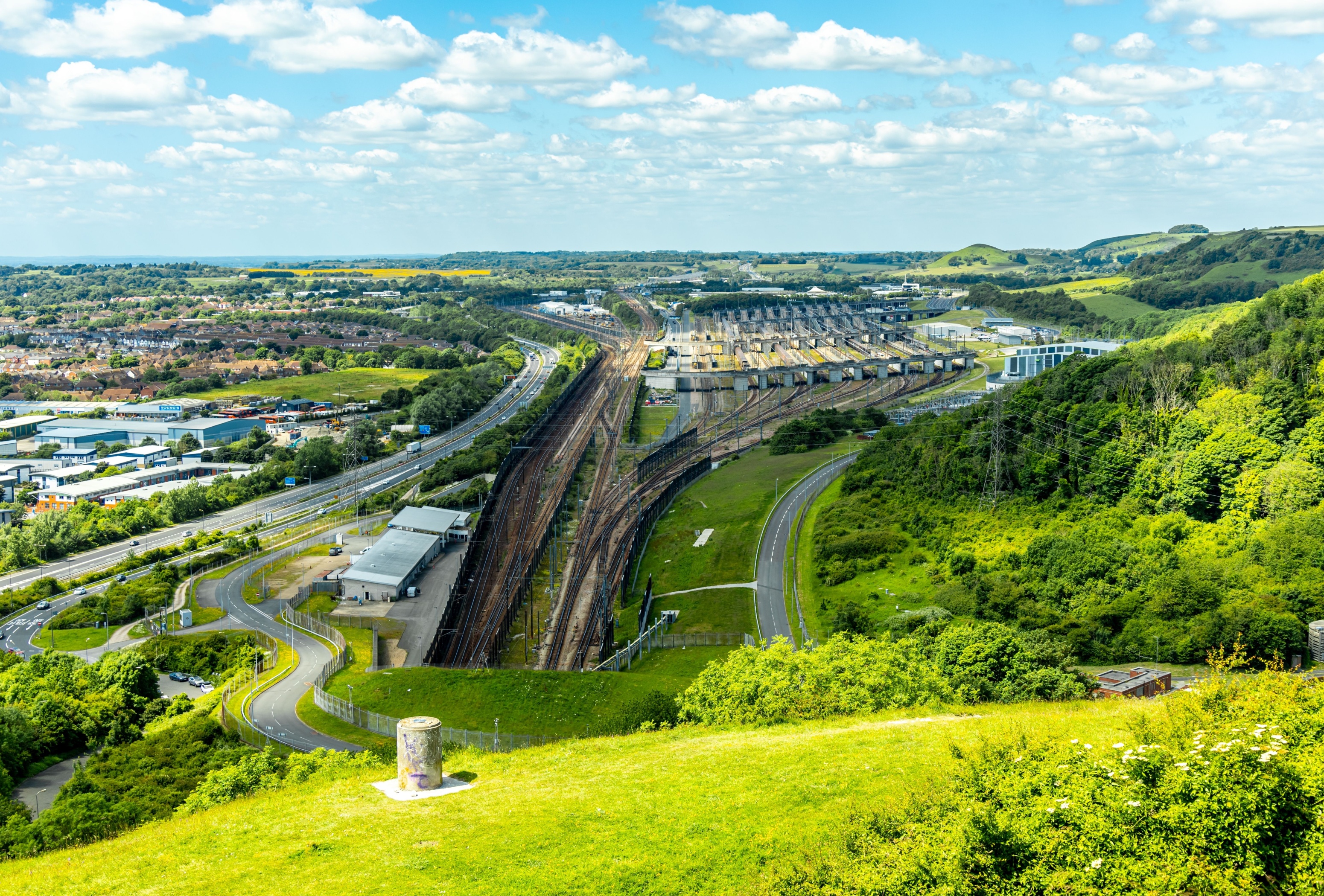 Entrance to the Eurotunnel in open countryside, photographed on a clear day.