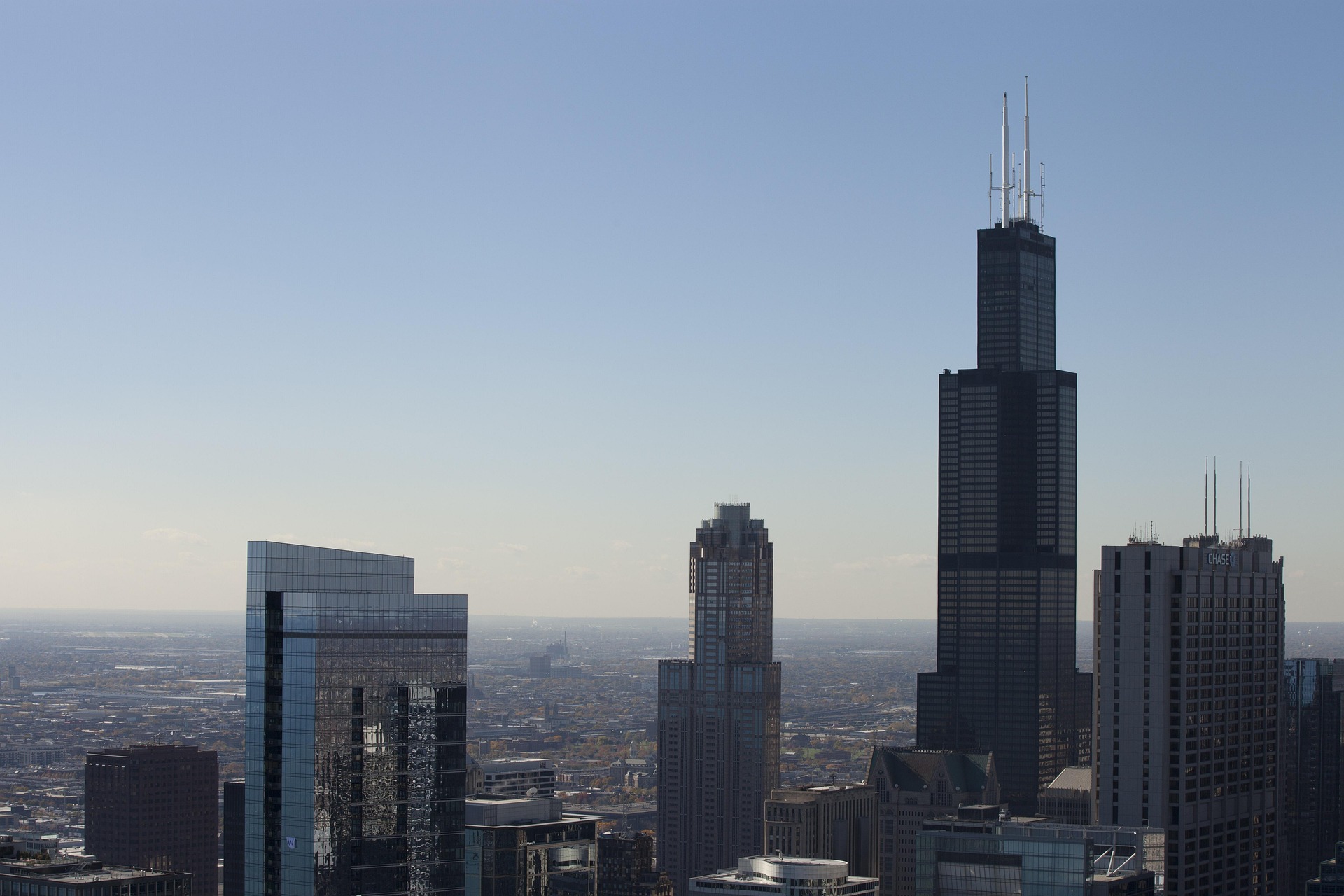 The image shows the Willis Tower, known for its structural design by Fazlur Rahman Khan.
