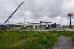 Installation of the roof structure with exposed fasteners and support structures.