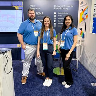 The Dlubal Software team, including Amy Heilig, Cisca Tjoa, and Matt Frantz, present at their booth during a conference in Atlanta.