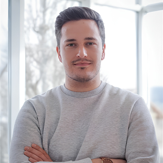 Matthias Ebnet, Team Lead Administration at Dlubal Software, standing with arms crossed in a modern office.