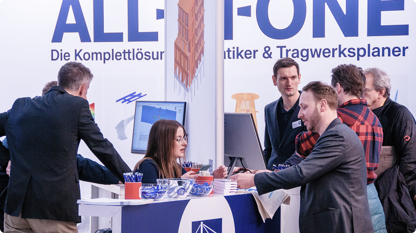 Dlubal Software representatives engaging with attendees at a trade show booth.
