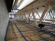 Travature dal pavimento al soffitto con diagonali in acciaio integrate in solette composte legno-calcestruzzo (© Indermühle Bauingenieure)