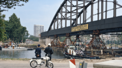 Ponte ad arco in acciaio sollevato su supporti provvisori durante il suo trasferimento attraverso il Canale Amsterdam-Reno