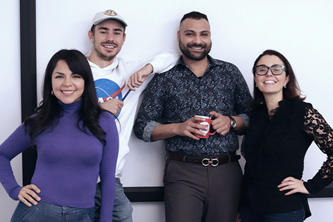 Colaboradores do departamento de vendas a discutir estratégias e a trabalhar em conjunto nas suas secretárias.